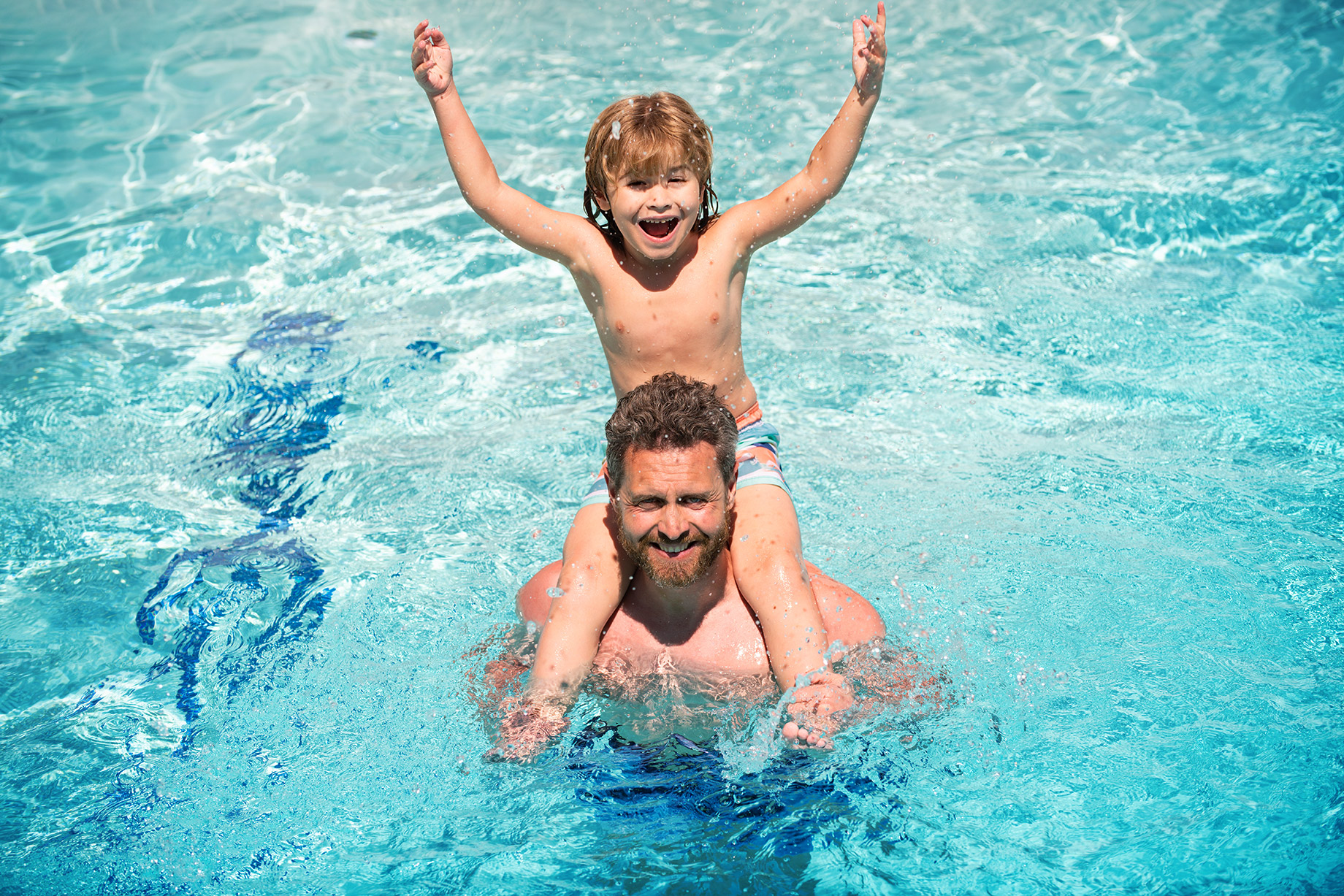 Summer Fun with a Father and Son in a Swimming Pool