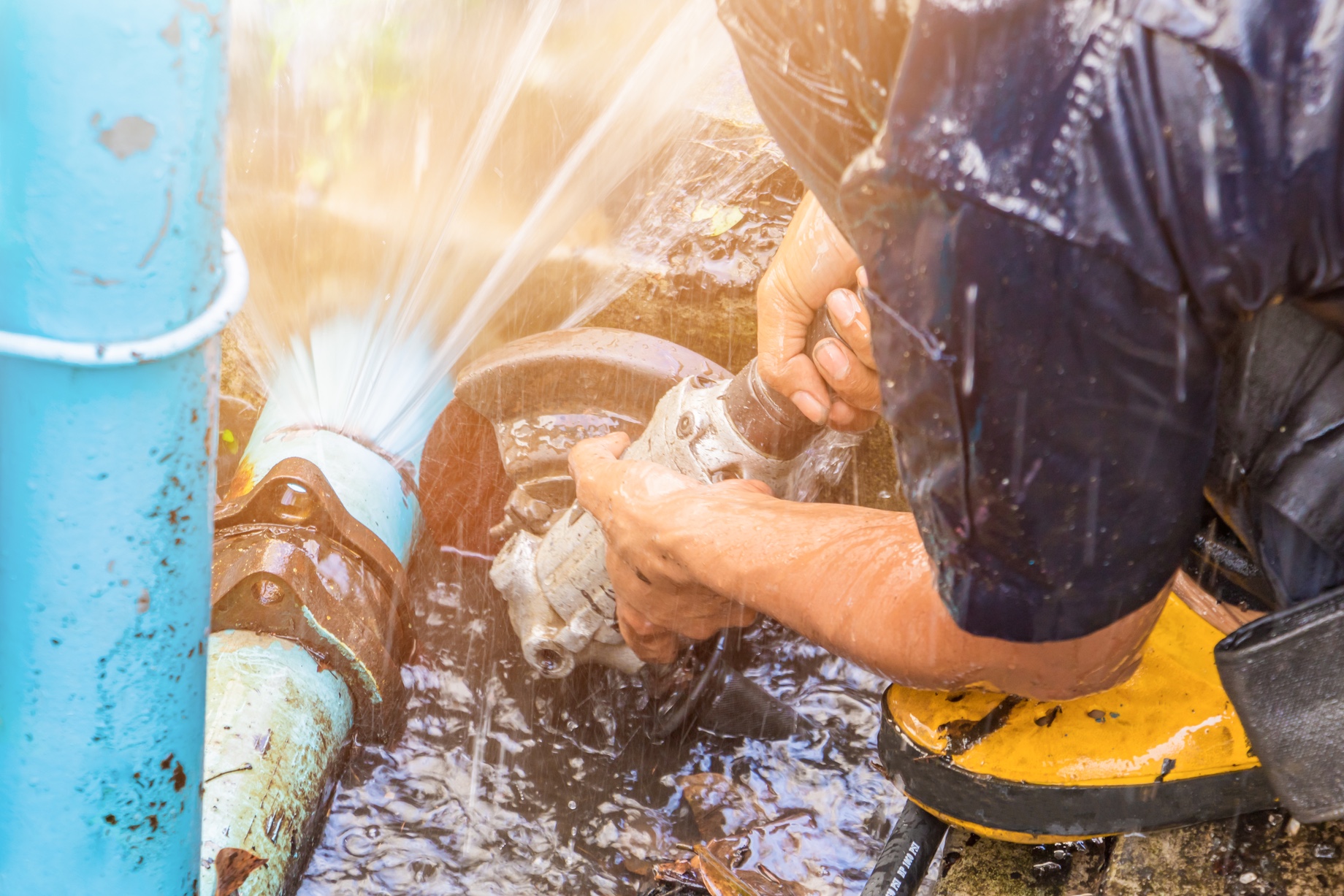 Plumber Repairing a Broken Pipe