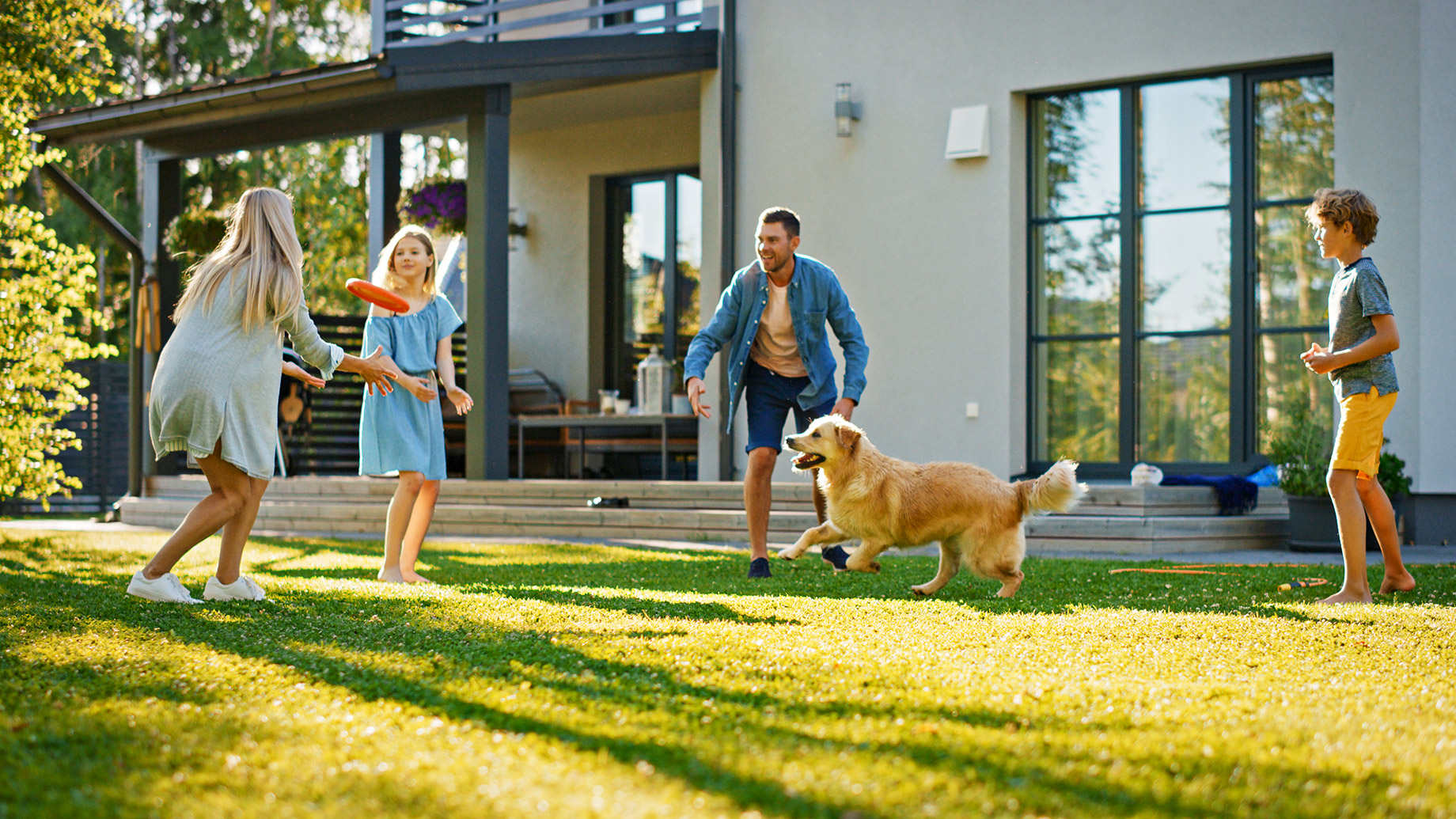 Family of Four with Dog - Playing Frisbee in the Backyard
