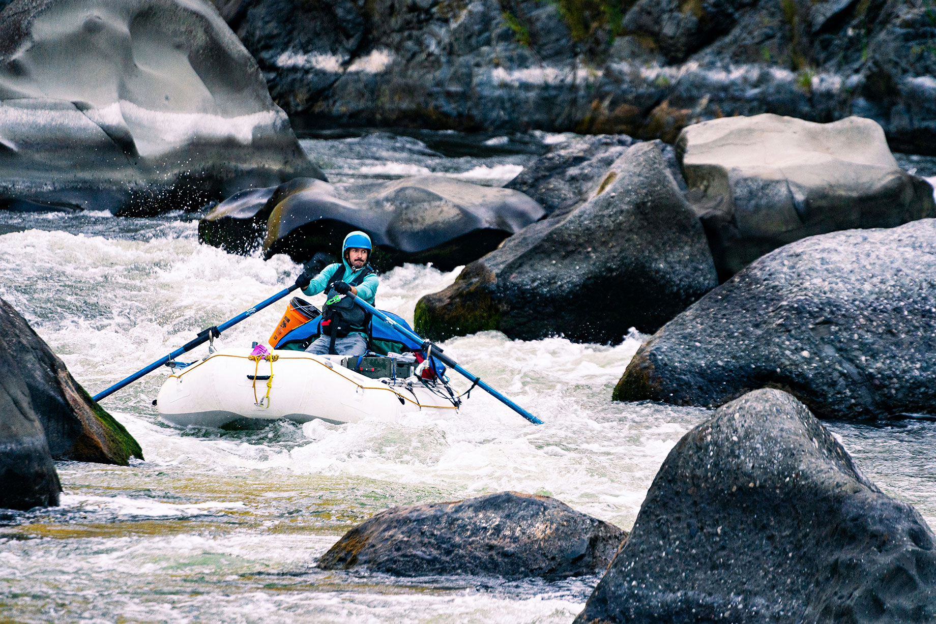 A Man in a Kayak on a River Surrounded by Rocks - Rogue River, Oregon, USA