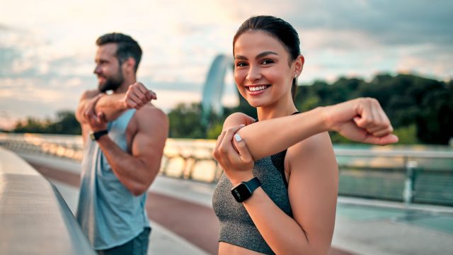Couple Stretching Outdoors Before Morning Run