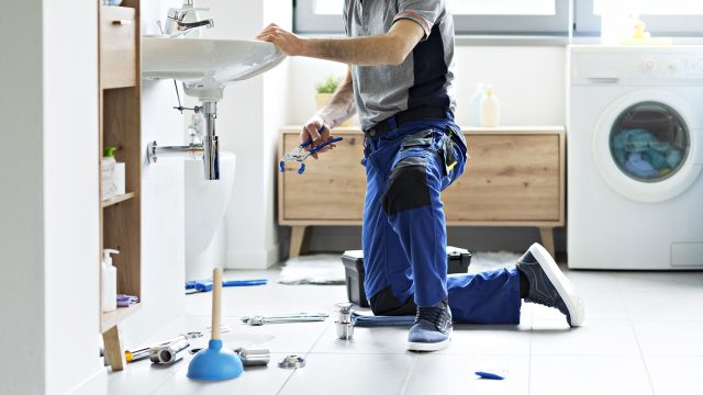 Professional Plumber Fixing a Bathroom Sink