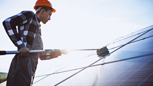 Man Working on Solar Panel Maintenance