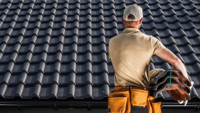 Professional Roofer with Roof Tiles