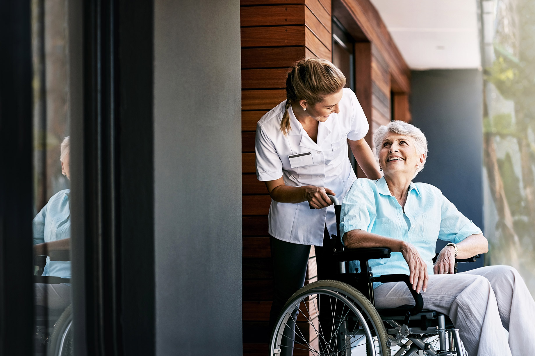 Senior Woman in a Wheelchair with a Caretaker