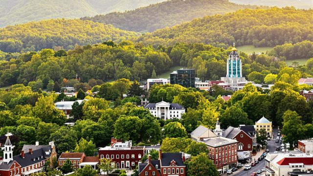 A picturesque view of Virginia showcasing the Blue Ridge Mountains, a colonial-style town, and a modern cityscape, highlighting the state's diverse landscapes and rich heritage."