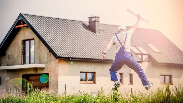 An Architect Freely Jumping with a Blueprint Plan in Hand