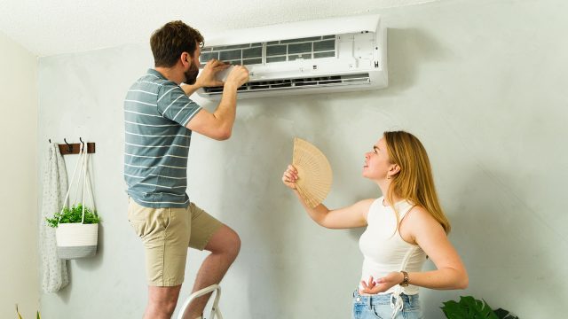 Checking AC Unit during Hot Summer