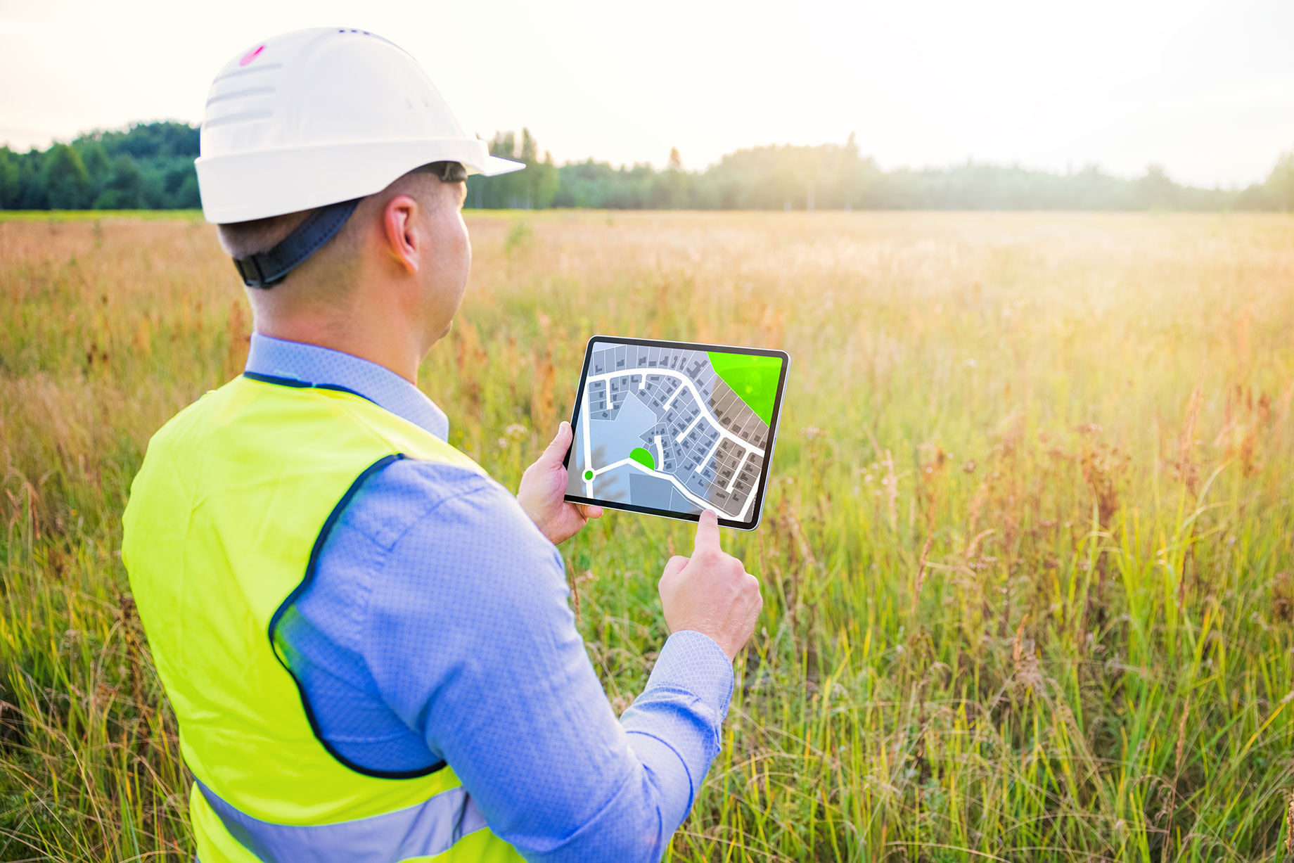 Architect Using a Tablet Surveying a New Residential Housing Building Land Plot