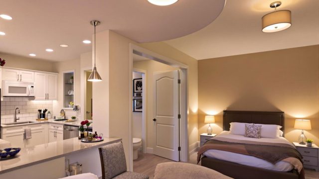 Showcasing a well-lit kitchen with overhead and under-cabinet lighting, a bathroom with ceiling and vanity lights, and a cozy bedroom with various lighting fixtures including table lamps and wall-mounted reading lights.