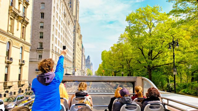 Tourists Sightseeing New York City from an Open Roof Bus