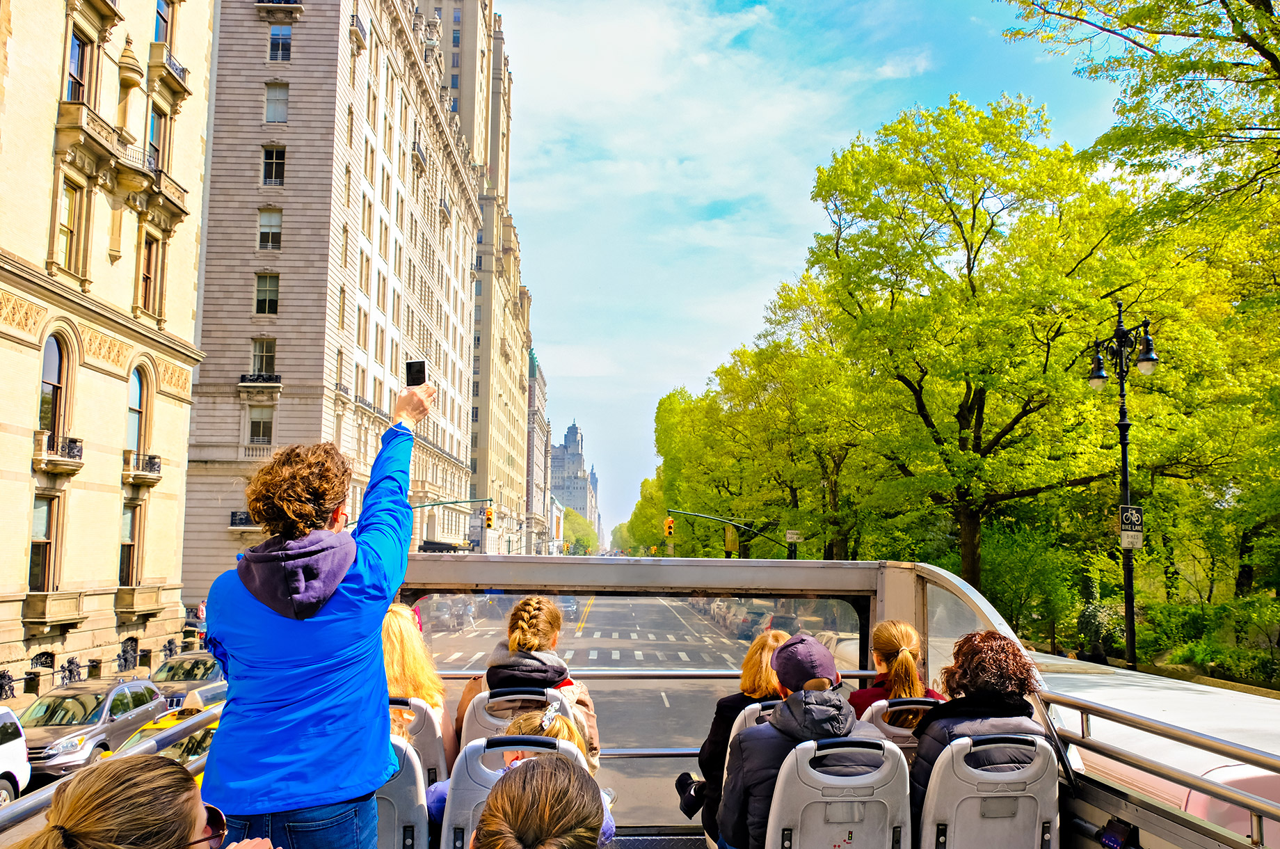 Tourists Sightseeing New York City from an Open Roof Bus