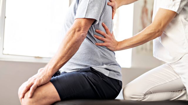A Modern Rehabilitation Physiotherapy Worker with a Senior Client