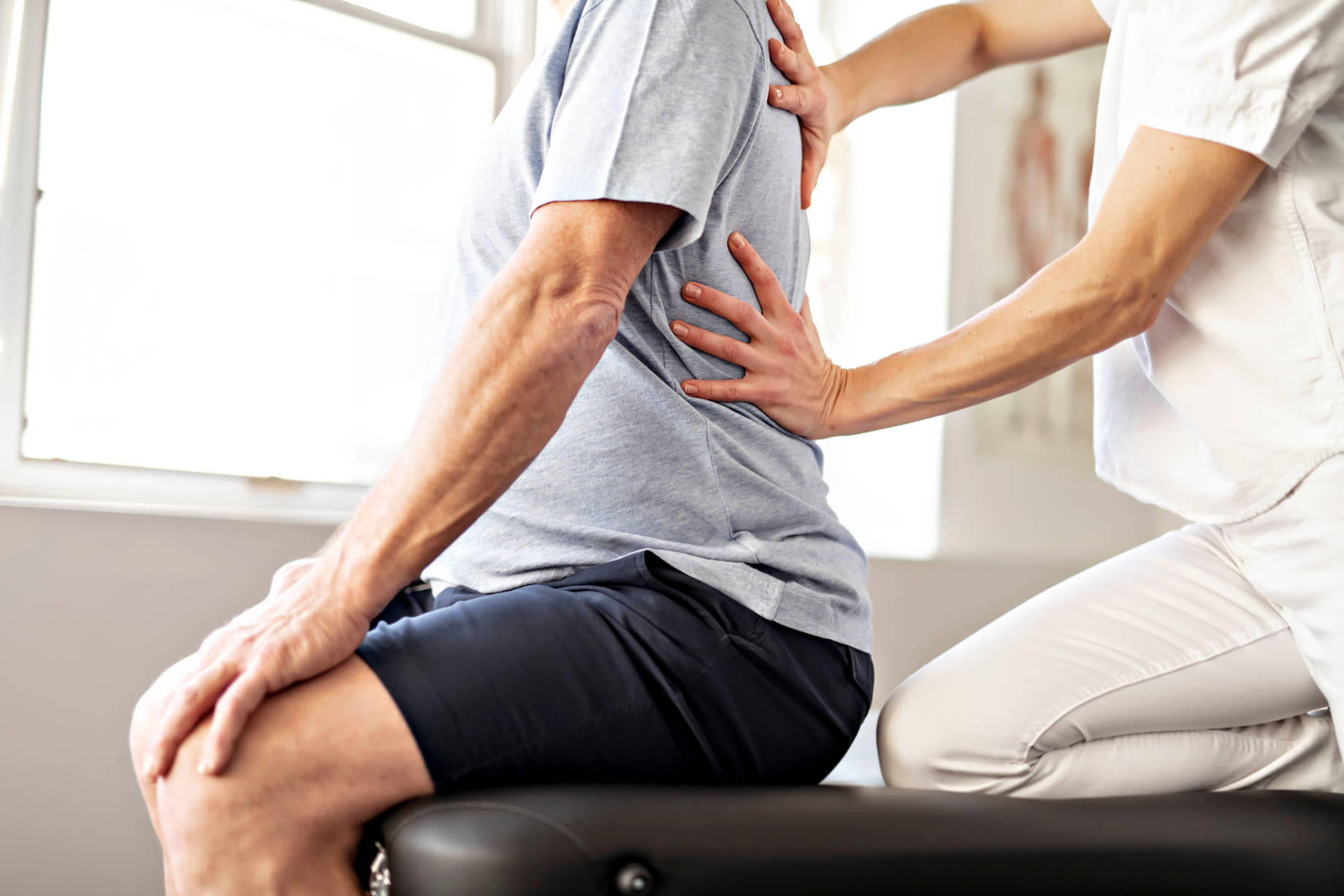 A Modern Rehabilitation Physiotherapy Worker with a Senior Client