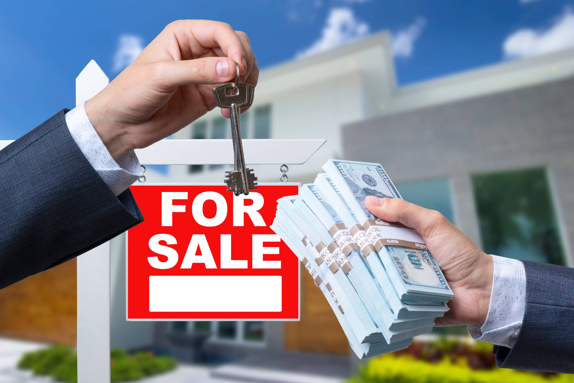 Agent Handing Over Keys of a House for Sale in Exchange for Cash