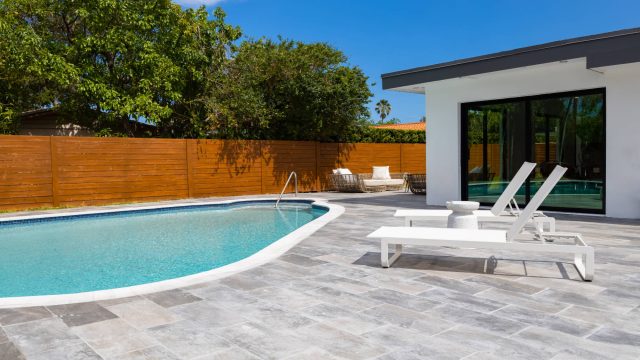 Backyard of House with Pool and Tiled Patio in the Highland Lakes neighborhood of Miami, Florida, USA
