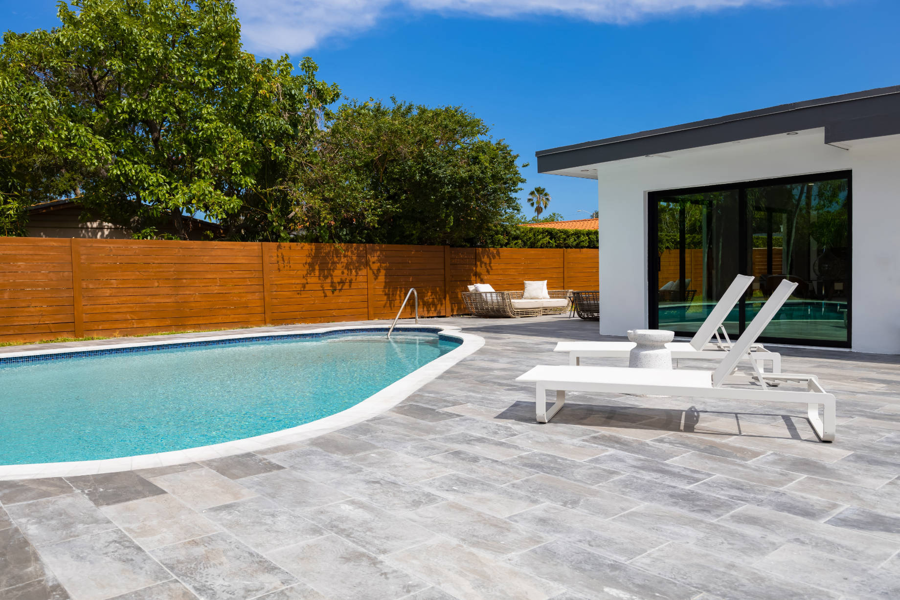 Backyard of House with Pool and Tiled Patio in the Highland Lakes neighborhood of Miami, Florida, USA