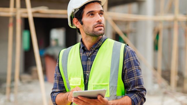 Civil Engineer Inspecting Home Under Construction