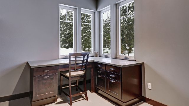 Corner Desk with Window View of Trees with Snow
