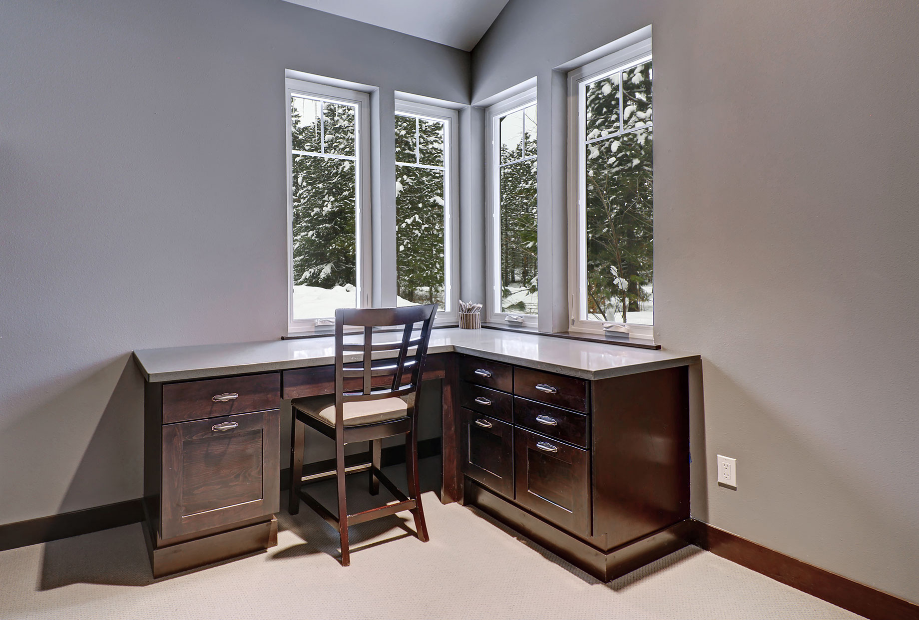 Corner Desk with Window View of Trees with Snow