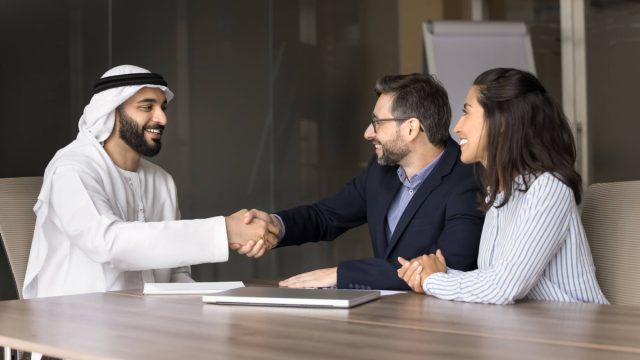 Couple Shaking Hands with a Real Estate Agent in Dubai