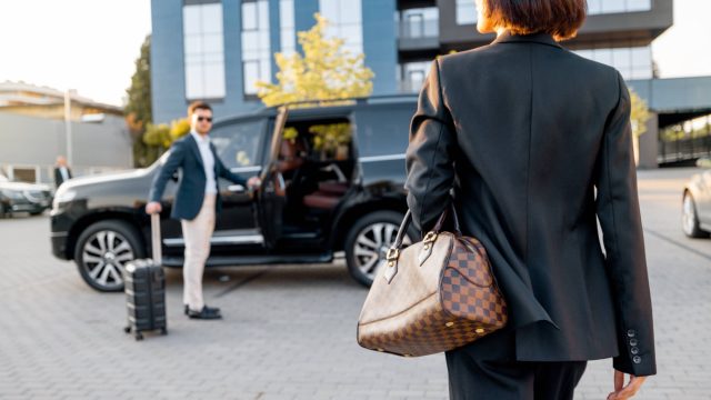 Elegant Businesswoman with Chauffeur Services for Business Travel
