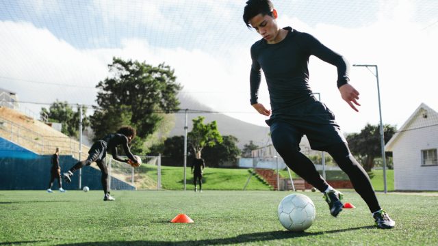 Football Player Training on a Soccer Field