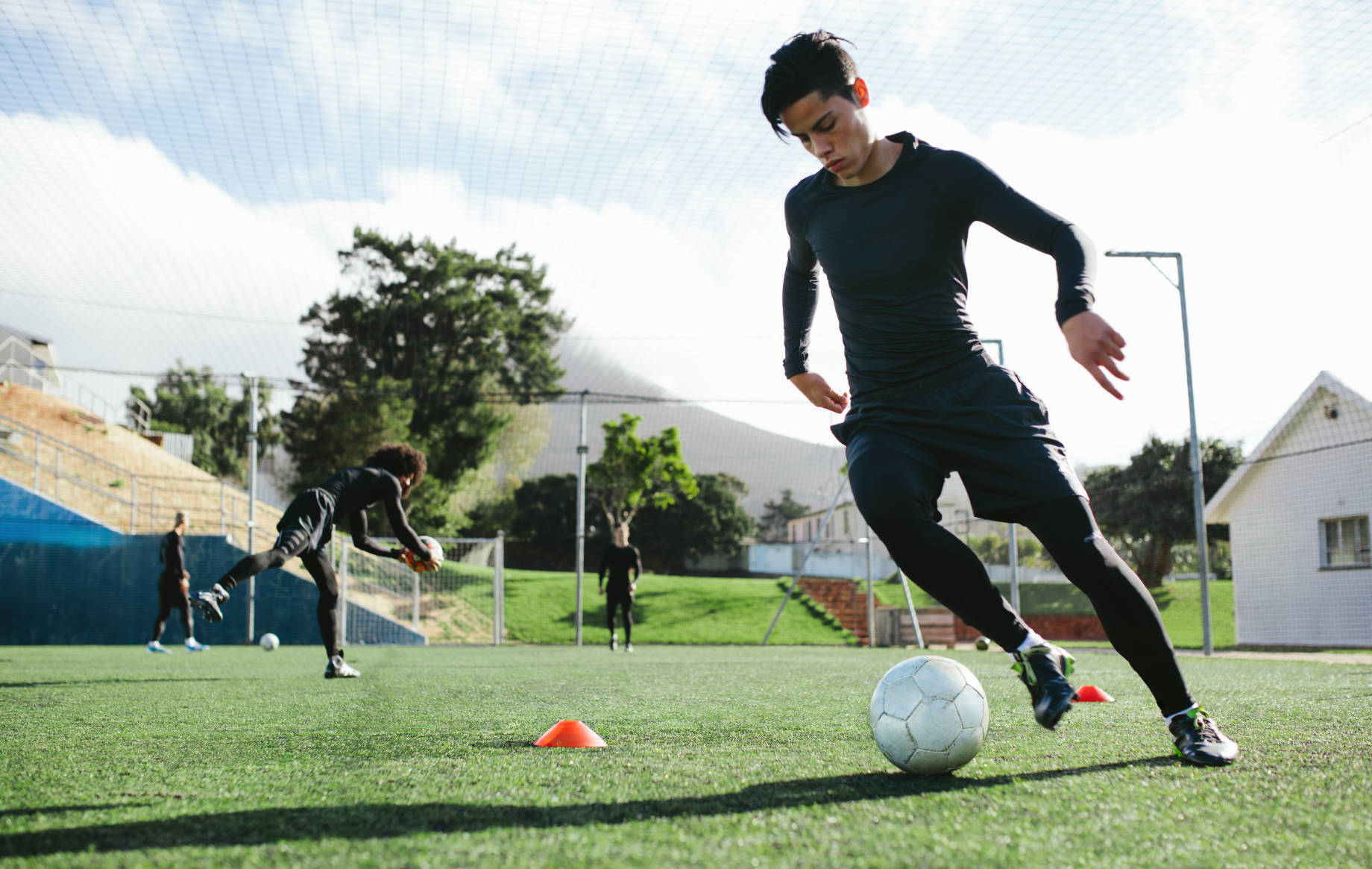 Football Player Training on a Soccer Field