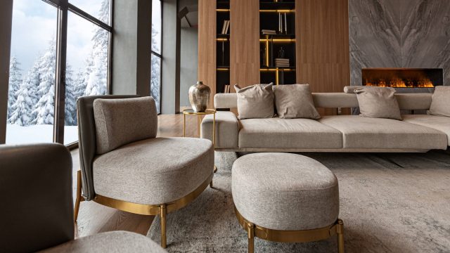 Living Room with Marble Wall Fireplace and Stylish Bookcase in a Chic Luxury House with Snow Outside