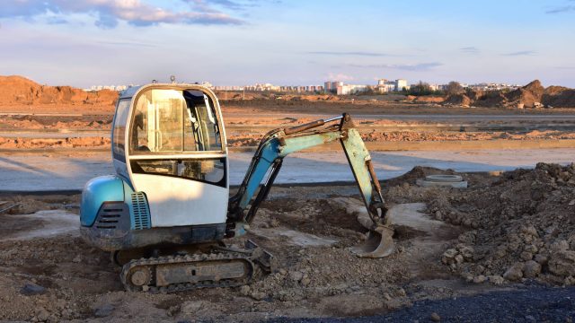 Mini Excavator Digging a Trench