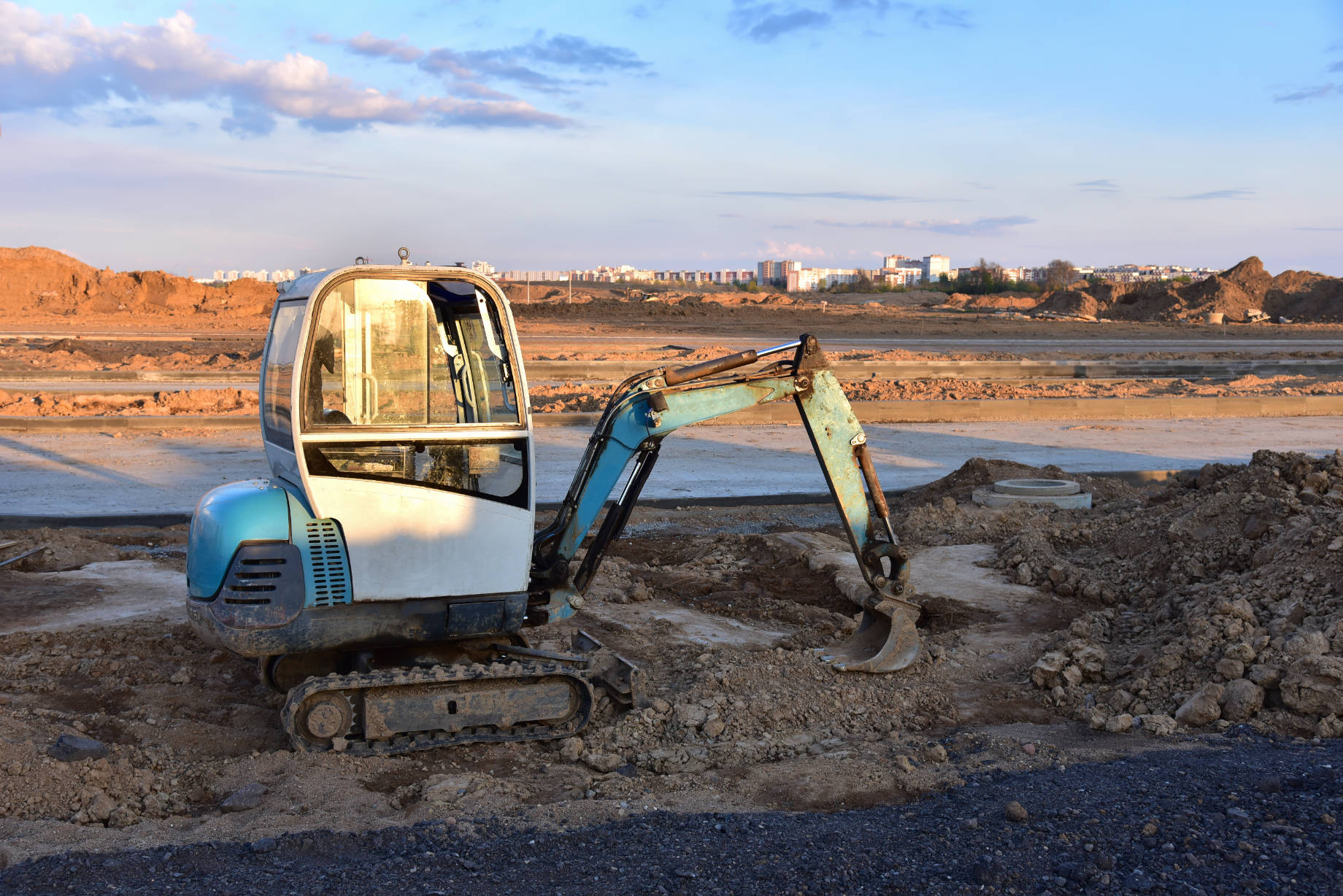 Mini Excavator Digging a Trench