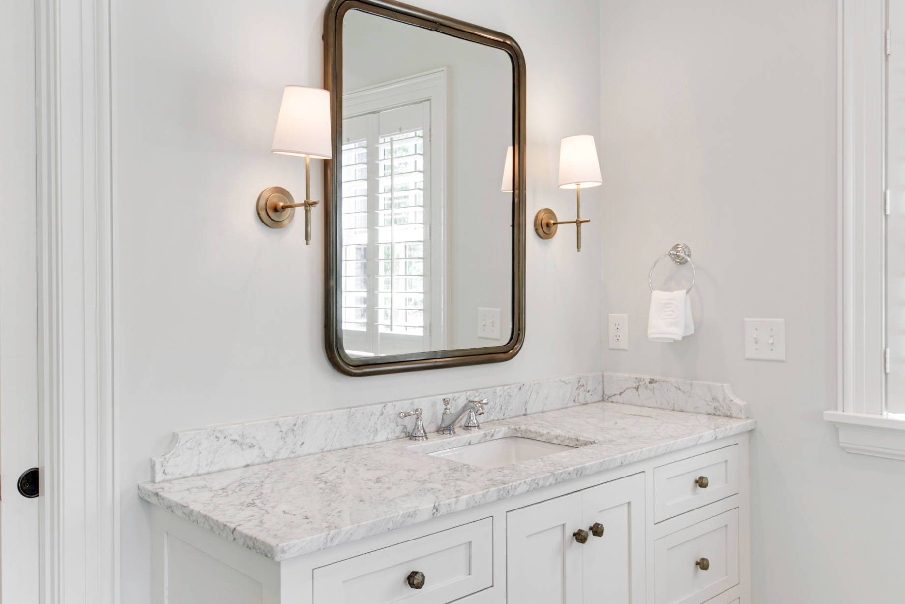 Modern White Bathroom Interior with Marble Sink and Mirror