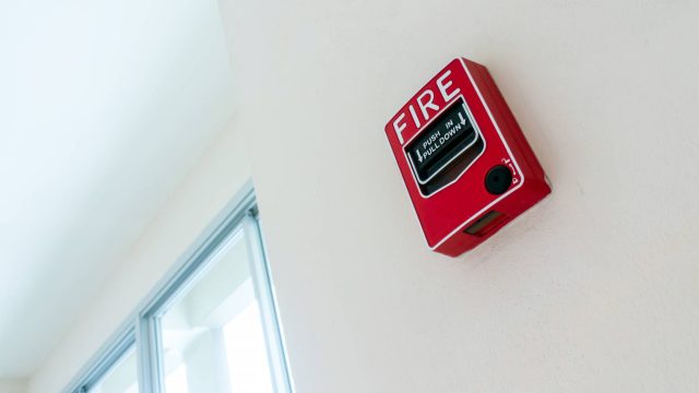 Red Fire Alarm Box Mounted on a Wall