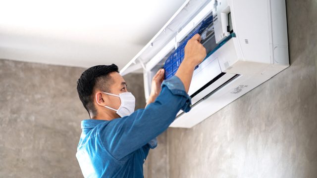 Technician Repairing AC Unit