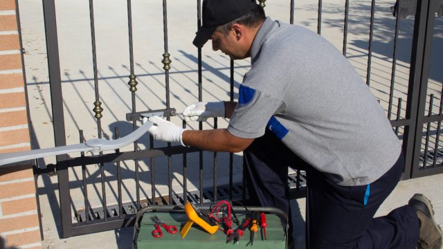 Technician Repairing Automatic Home Gate
