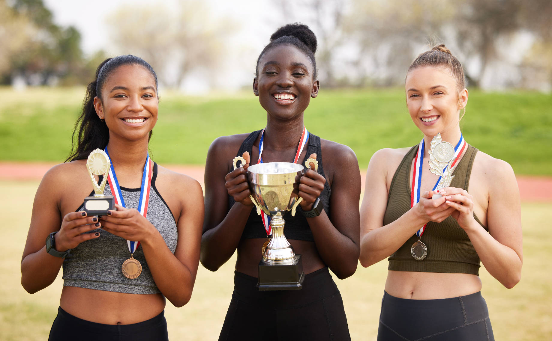 Young Women with Trophies Celebrating Their Athletic Sport Achievements