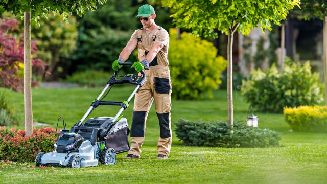 A Professional Landscaper Operating A Lawn Mower