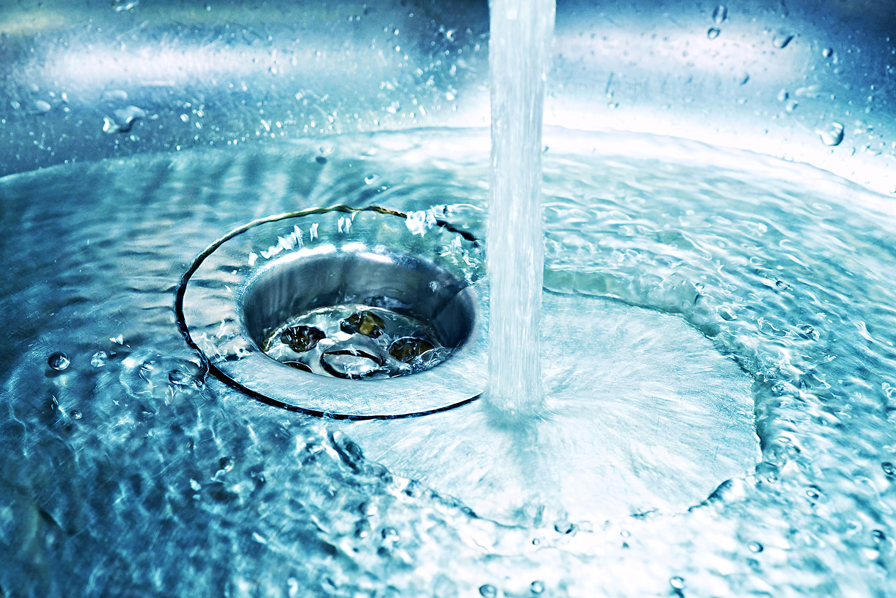 Drain in Sink with Flowing Water