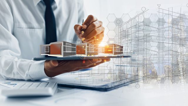 Engineer Holding a Tablet with House Construction Planning