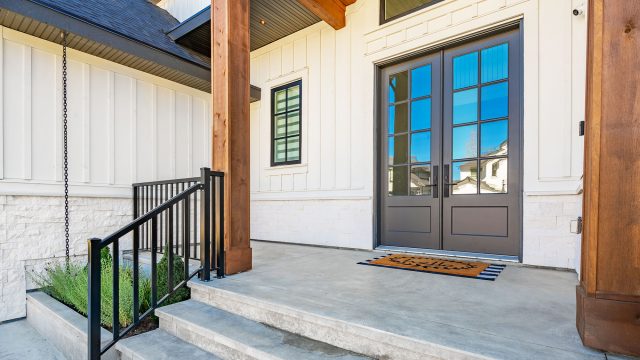 Entry Door with Windows to Home from Cement Patio