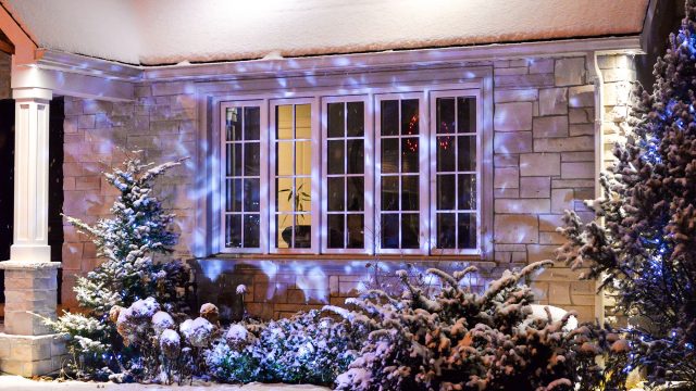 House Decorated with Lights in the Snow for Christmas
