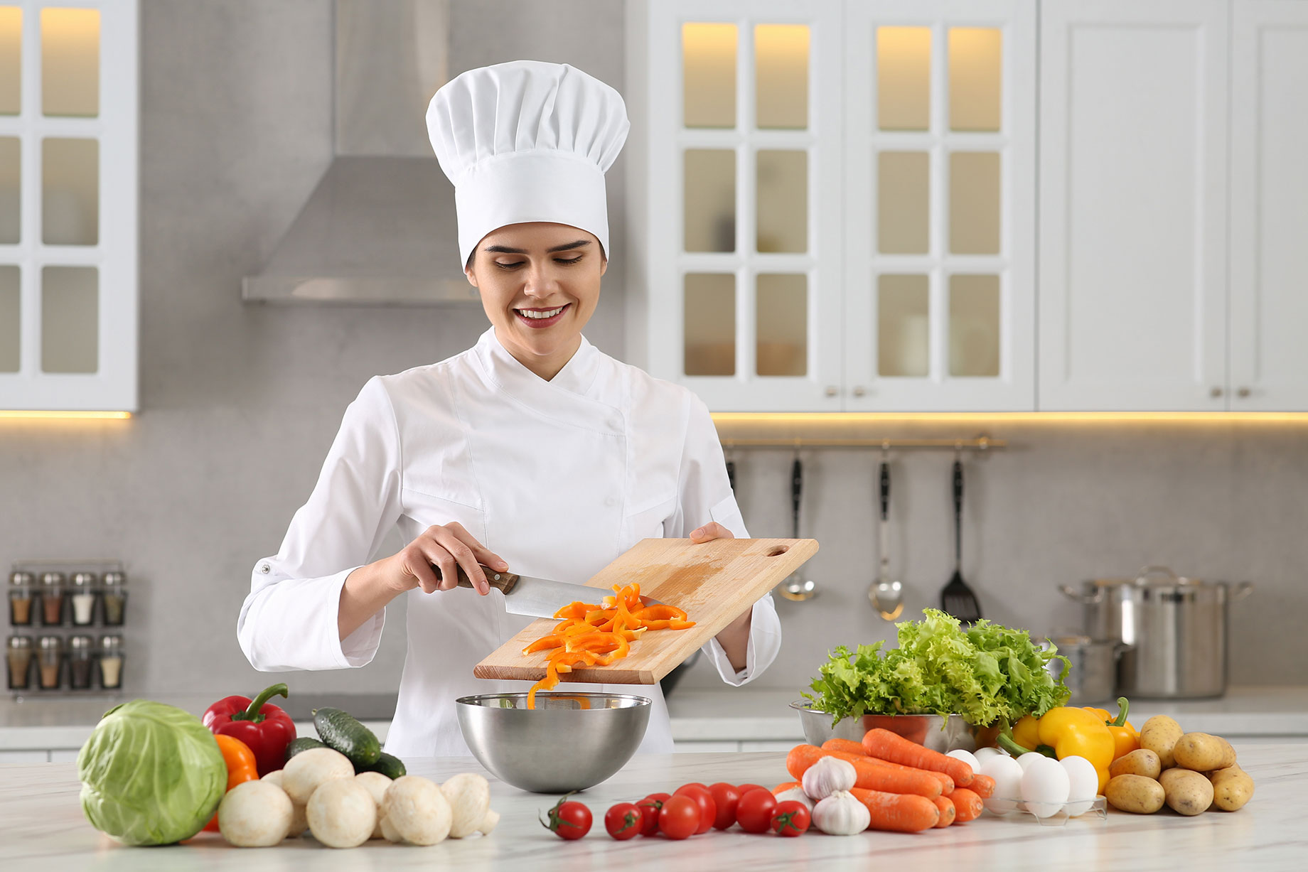 Professional Chef Cutting Vegetables in Modern White Kitchen