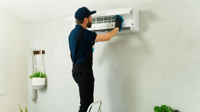 Technician Repairing AC Unit