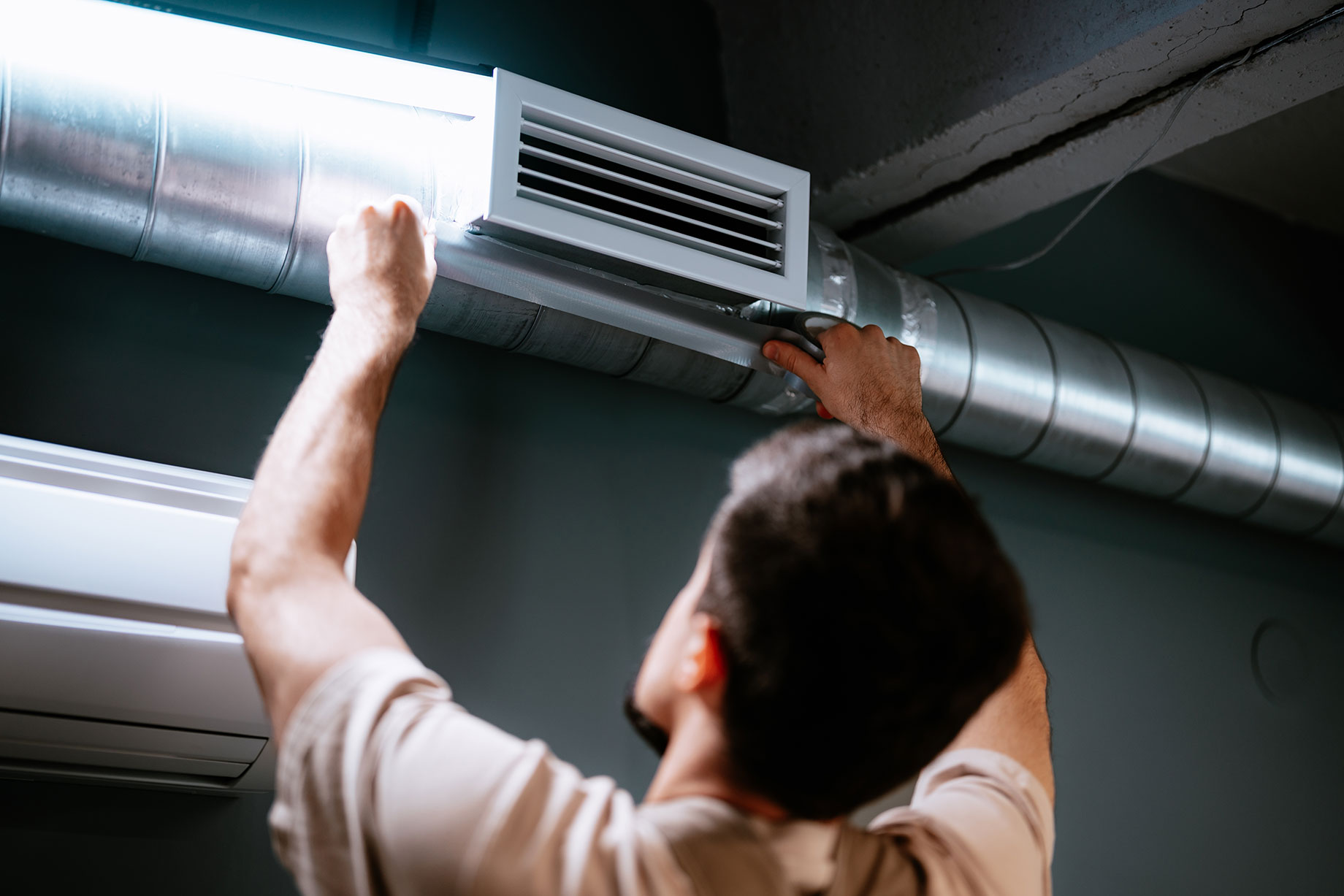 Technician Repairing Air Duct System