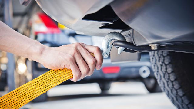 Attaching Yellow Towing Strap to Car