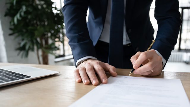 Businessman Signing Certificate Document