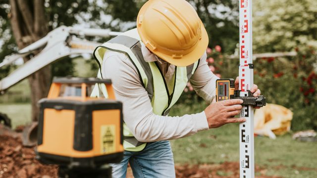 Civil Engineer Using a Land Surveying Tool