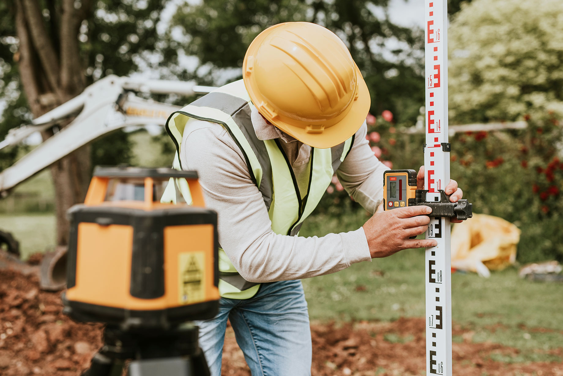 Civil Engineer Using a Land Surveying Tool