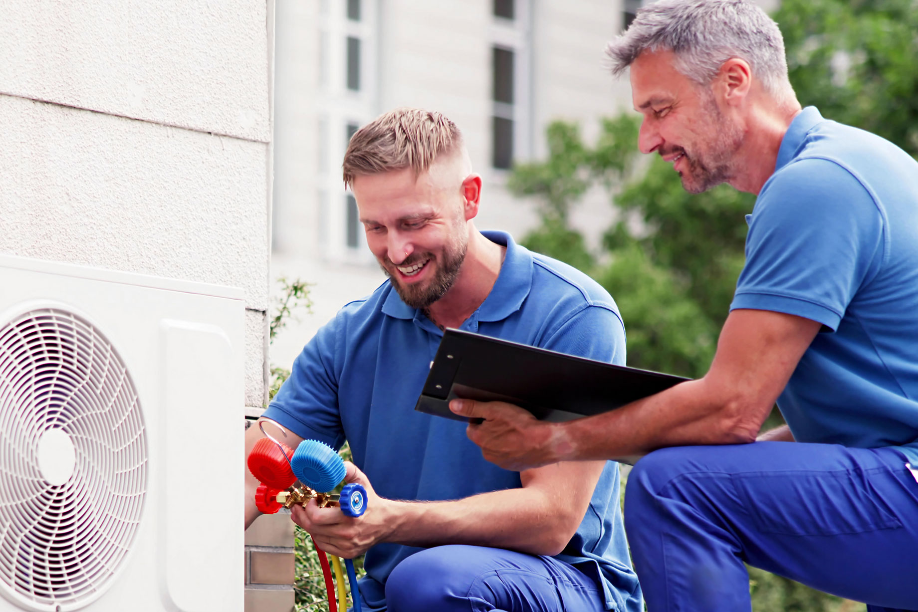 Experienced Technicians Repairing Air Conditioning System with Heat Pump