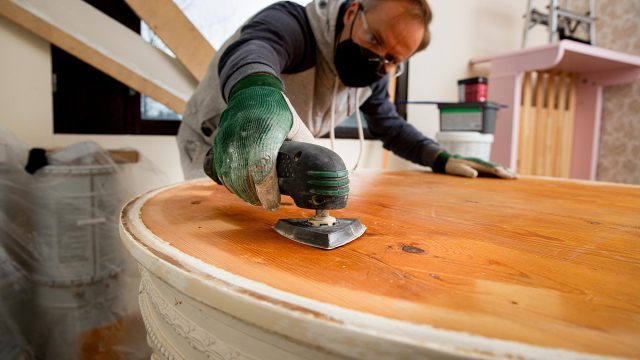 Man Restoring Old Wooden Table